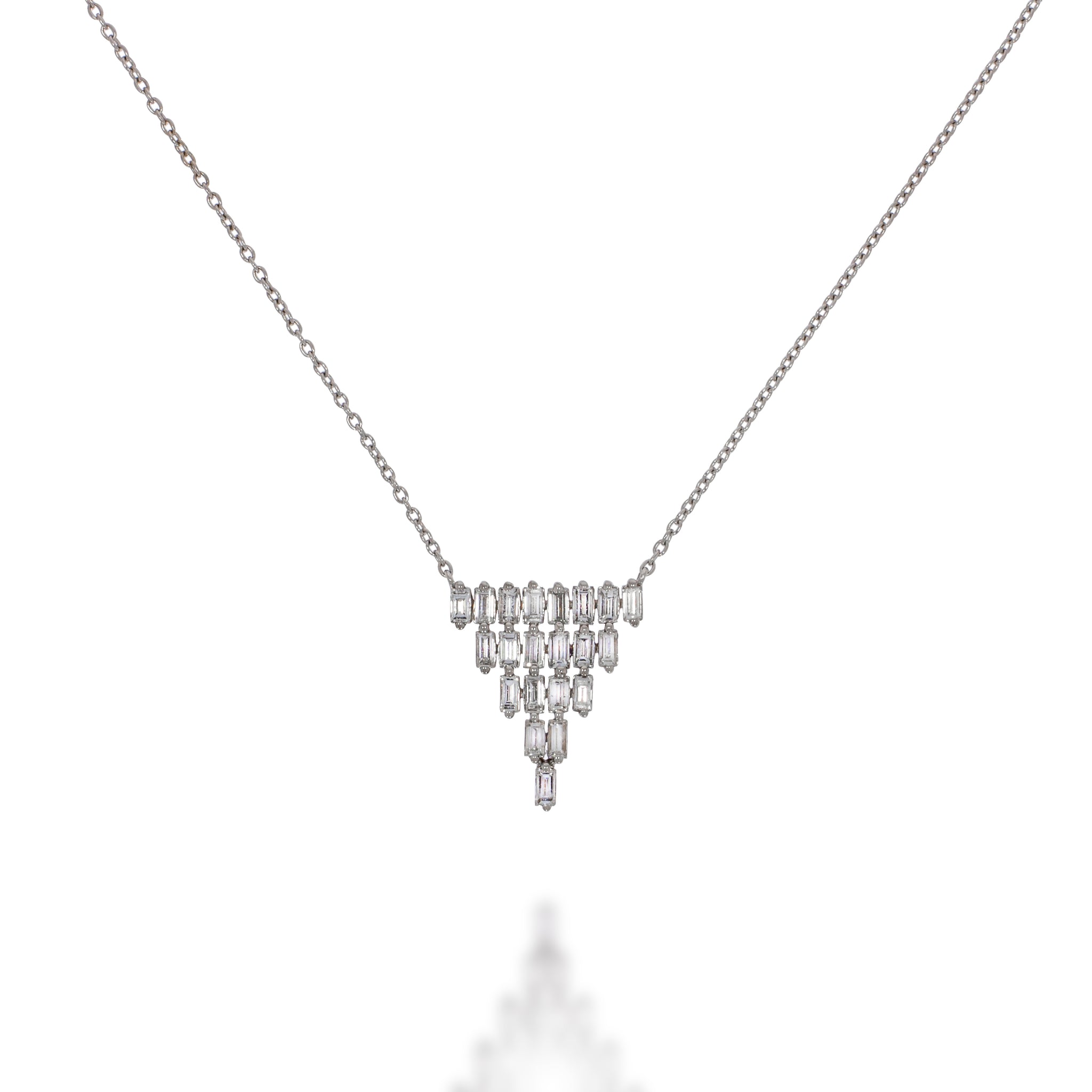 A pendant made up of rows of baguette diamonds forming a flexible, glittering and luxurious triangle. 1.09 carat diamonds in 18k white gold.