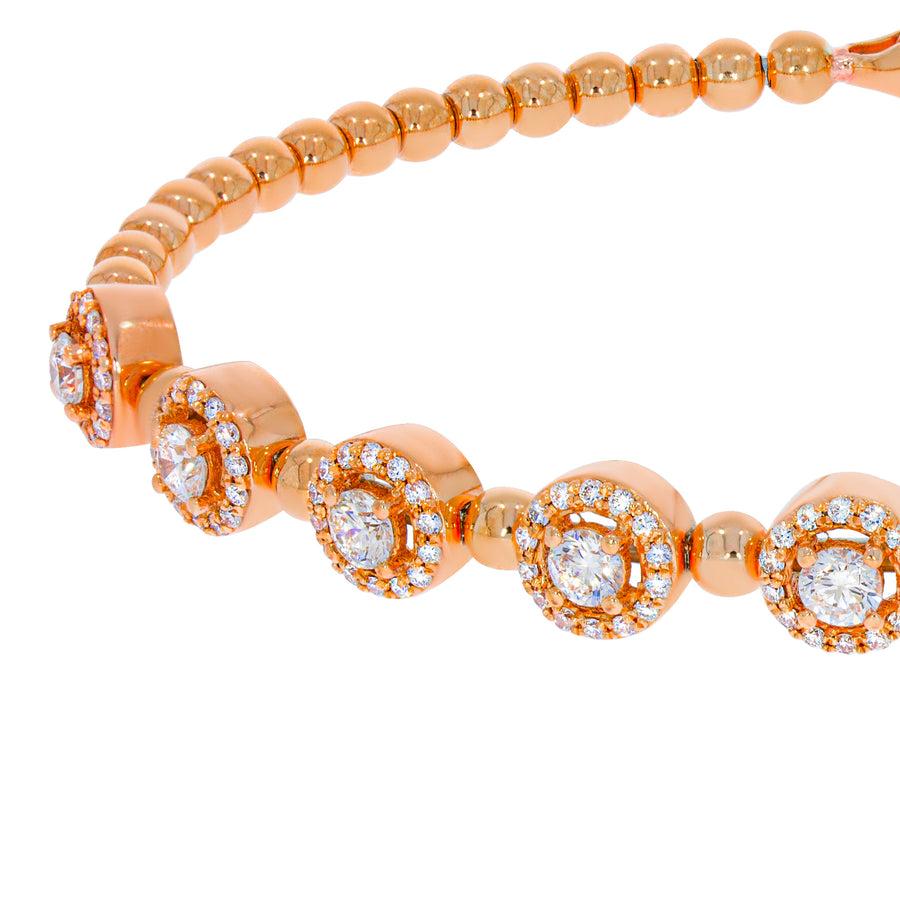 Flexible bracelet, Diamond bracelet with 18k rose gold beads interlocking. 8 round brilliant diamonds with halo diamonds around them.